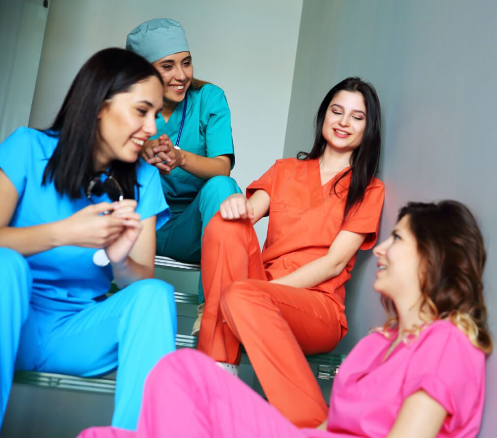 Women in different colour healthcare uniforms